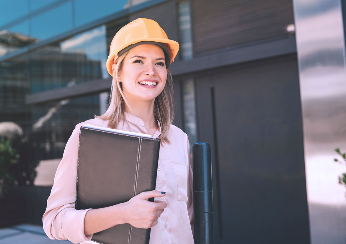 Woman with hard hat holding a portfolio